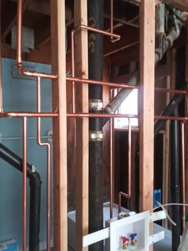 picture of new plumbing copper piping being installed in a home