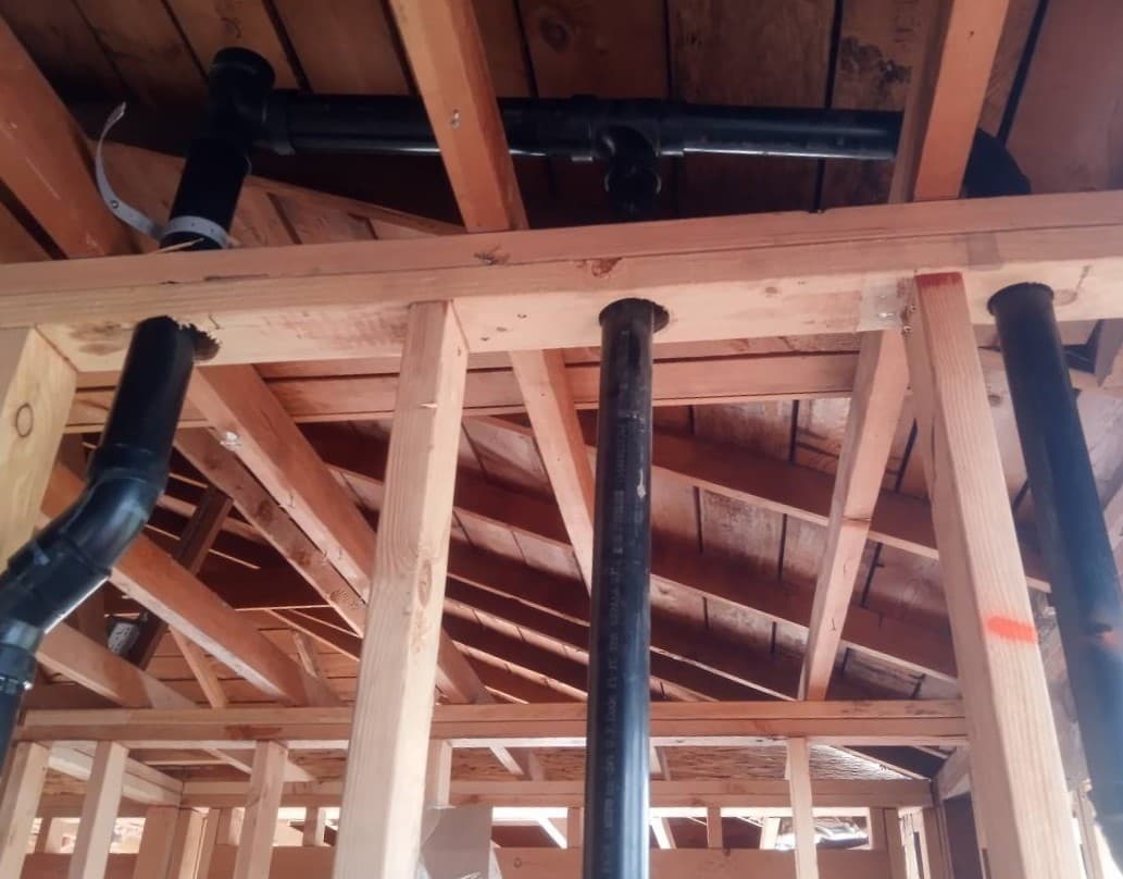 picture of a home being framed and plumbing being installed