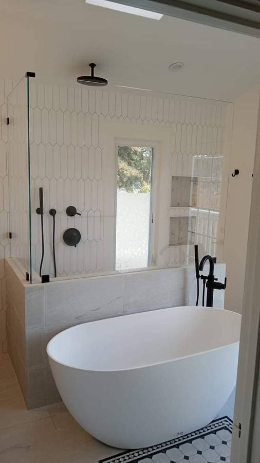 picture of a remodeled bathroom including a luxury bathroom tub and faucet